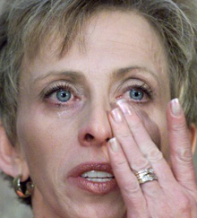 Dar Heatherington tears up while talking to reporters last summer in Lethbridge, Alta.